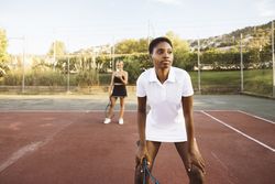 Two young women playing tennis