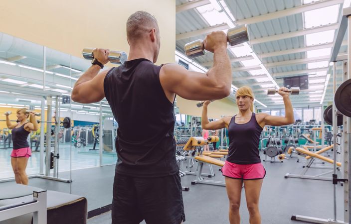 Man and woman training upper body together