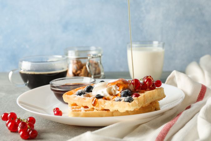 Composition of breakfast with belgian waffles, space for text