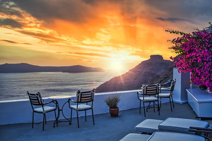 Deck with seating over looking Aegean Sea with the sun going down