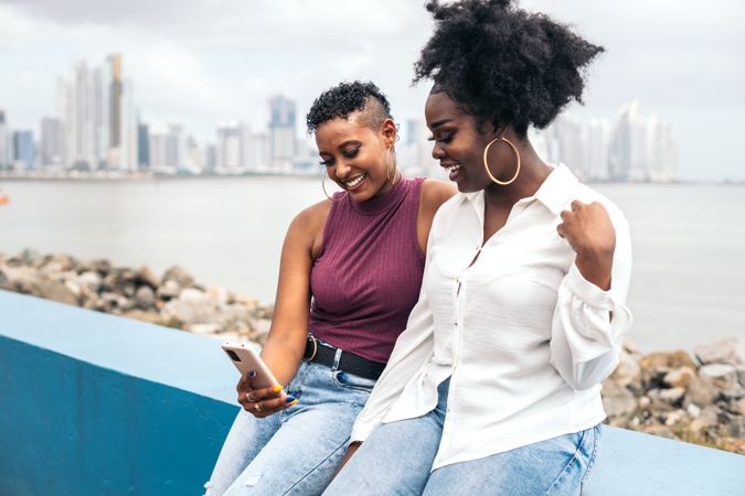 Stylish friends taking selfies along the boardwalk in Panama City