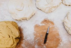 Knife near dough and flour
