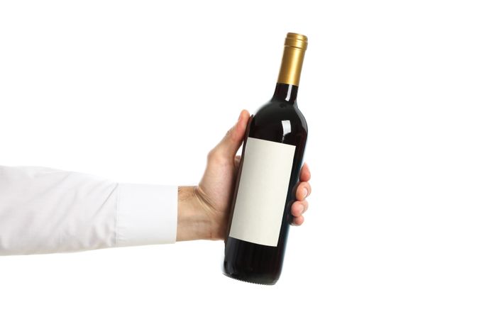 Male hand holding bottle of wine, isolated on plain background