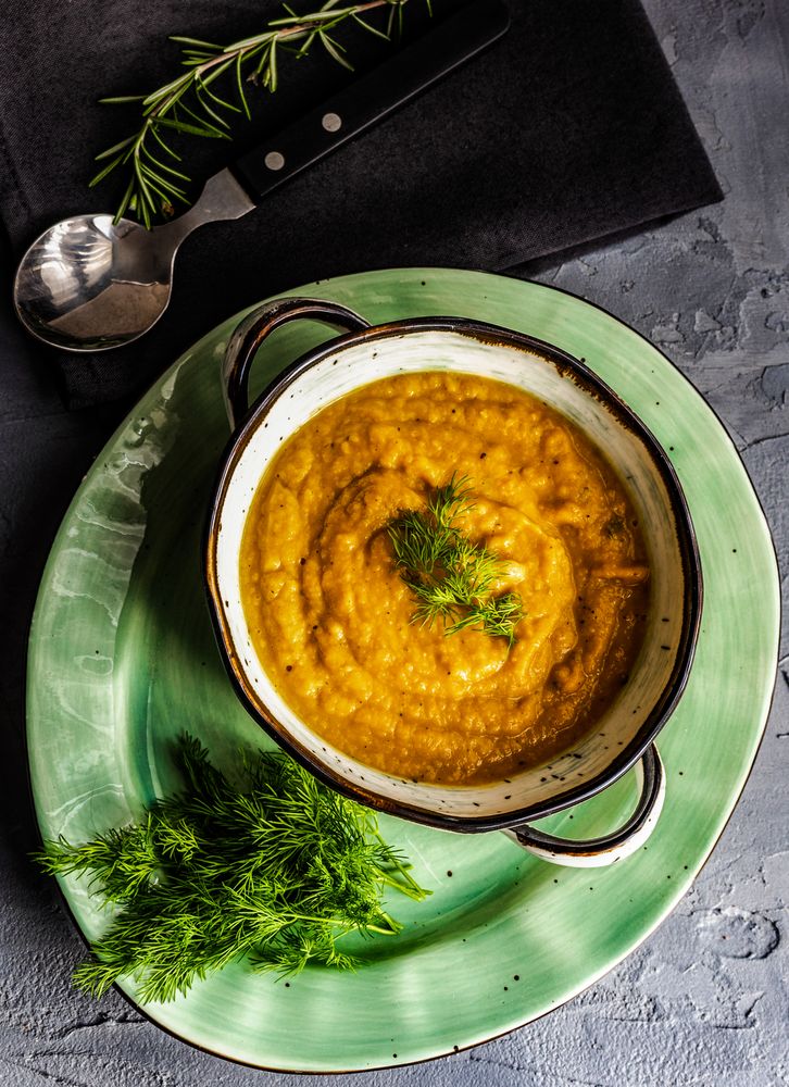 Top view of hearty pumpkin soup with garnish 