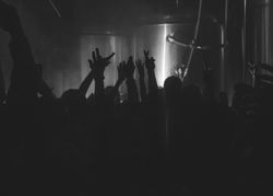 London, England, United Kingdom - Nov 9, 2022: dark shot of hands up on the dance floor