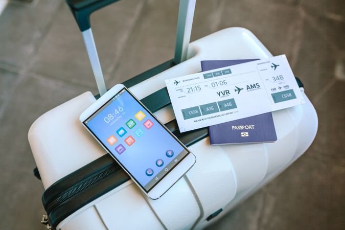 Suitcase with airline ticket, passport and mobile