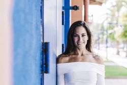Portrait confident smiling young woman on urban street