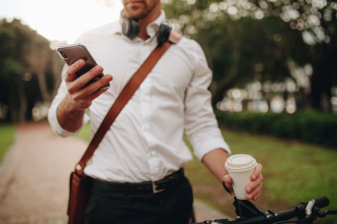 Businessman using mobile phone while walking to office