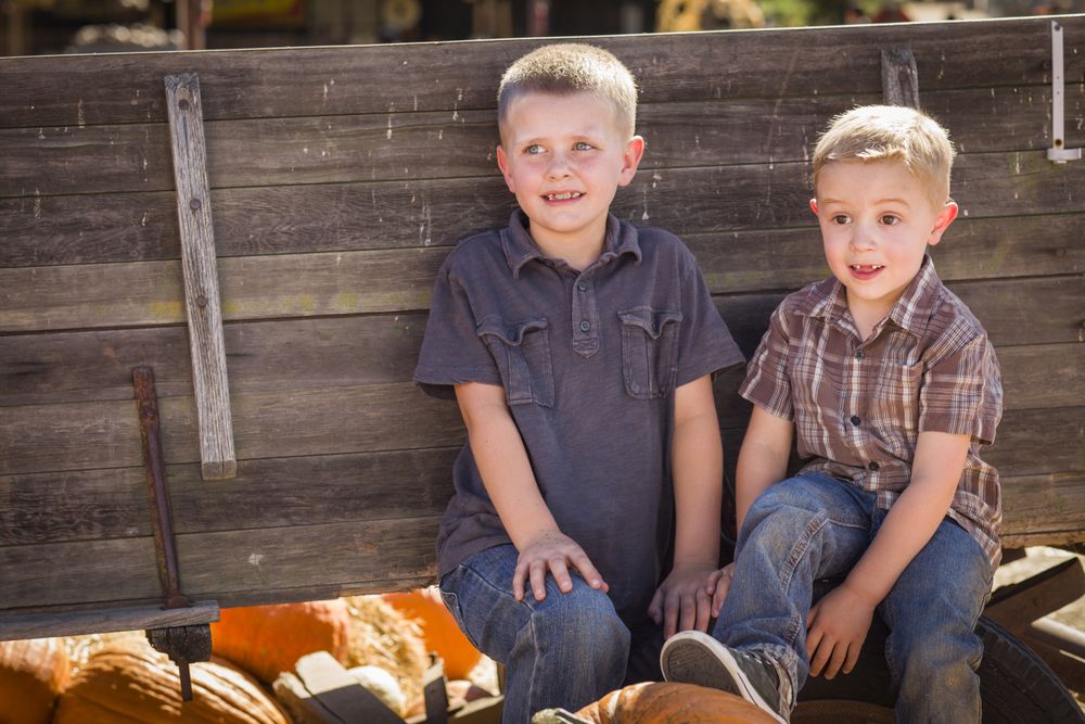 Two Boys Having Fun at the Pumpkin Patch
