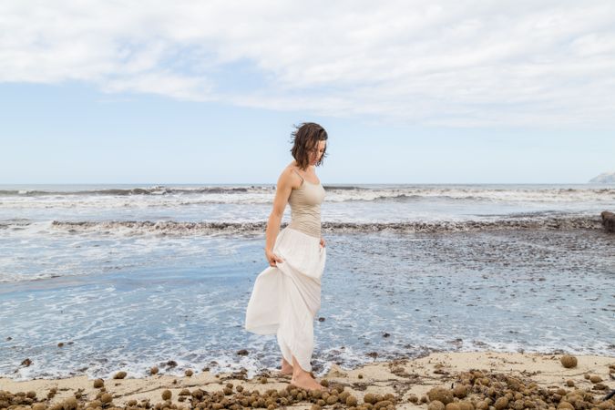 Charming young woman on shore near water