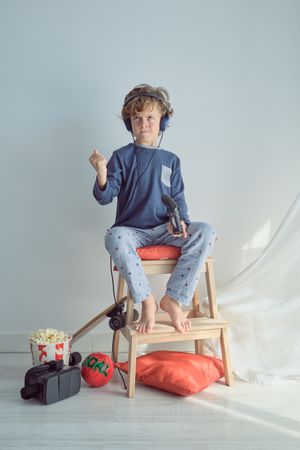 Upset boy in headphones playing video game
