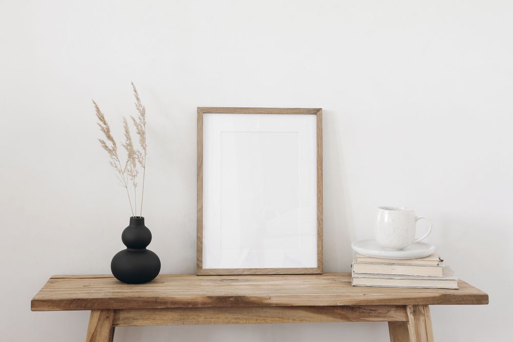 Entry table with mockup frame and vase and decorative reeds