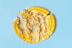 Smashed cake top view on blue background