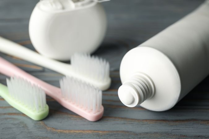 Tools for dental care on wooden background, close up