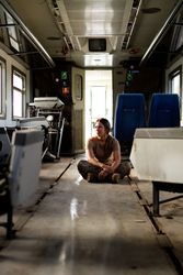 Female soldier on floor of military vehicle