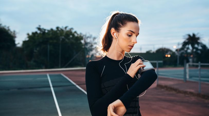 White female in sportswear and sports armband at the tennis court