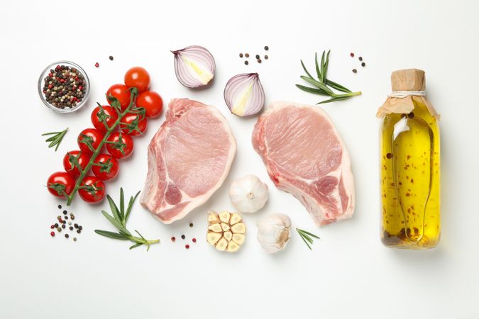 Composition with raw meat and ingredients on light background, top view