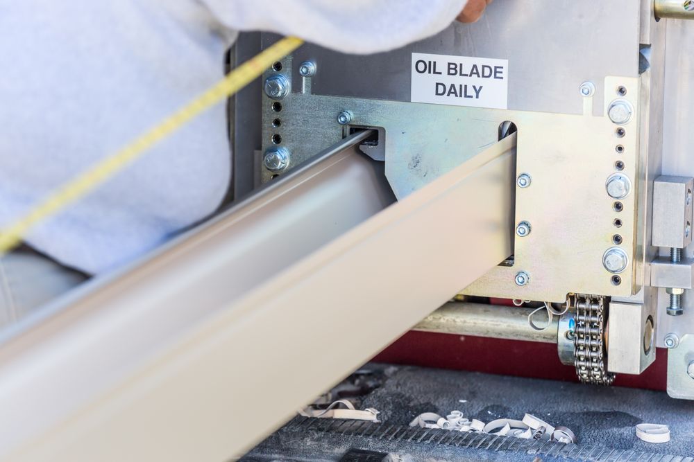 Worker Measuring Rain Gutter Processing Through Seamless Shaping Machine