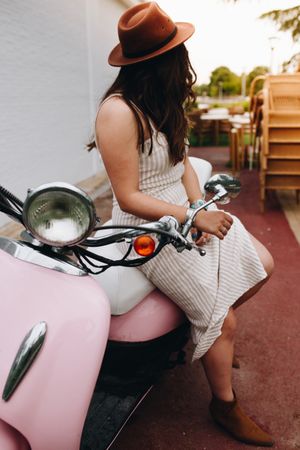 Woman smiling with face up sitting on motorbike