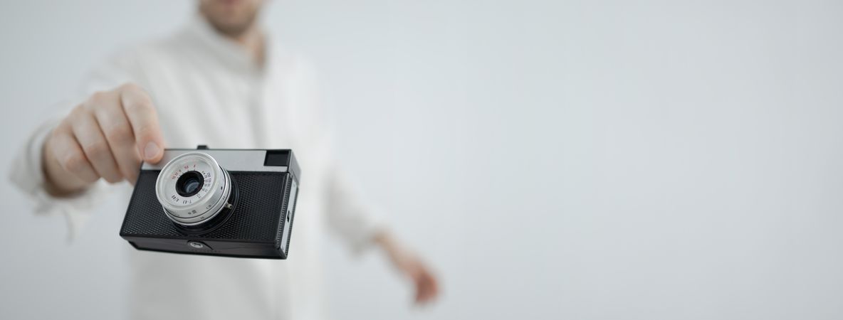 Retro camera floating in hand