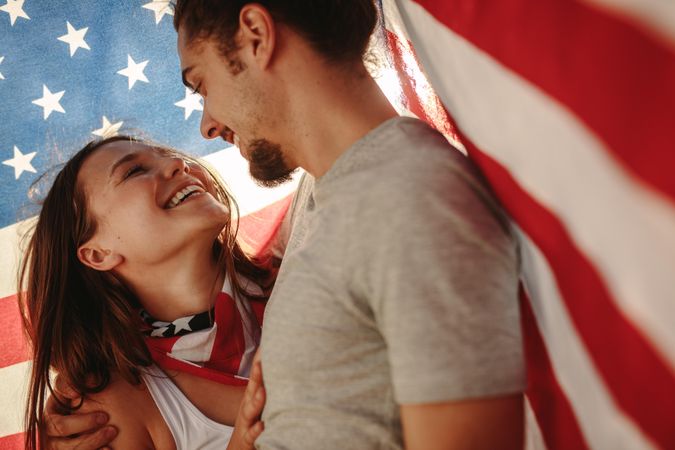 Affectionate couple under USA flag