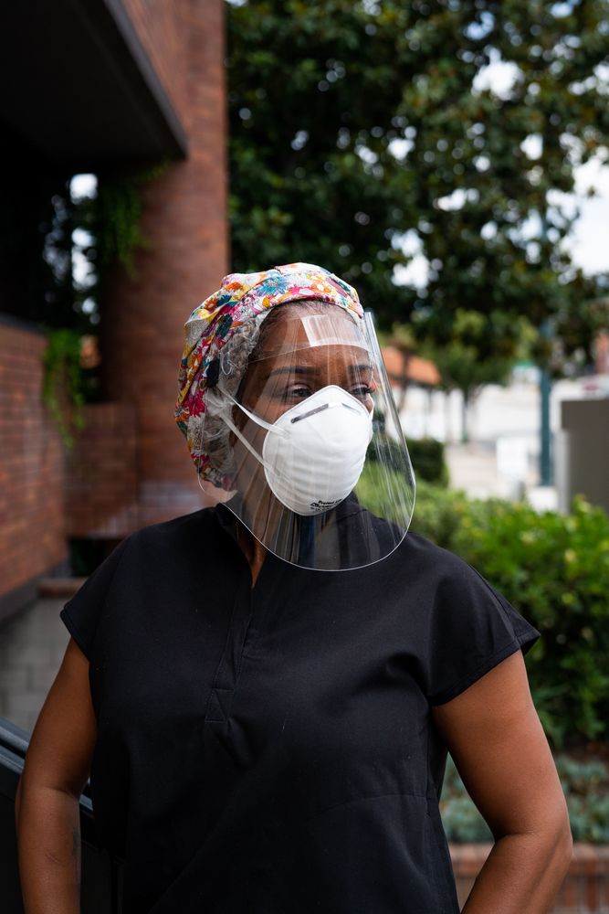 Portrait of thoughtful nurse outside in PPE looking away from camera