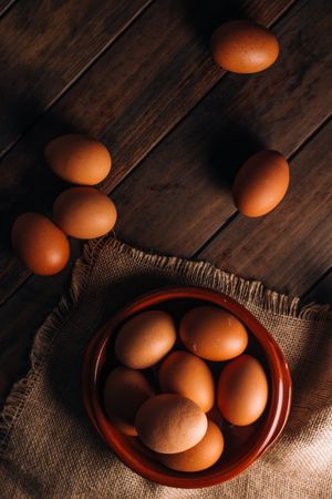 Chicken eggs on napkin on wooden table