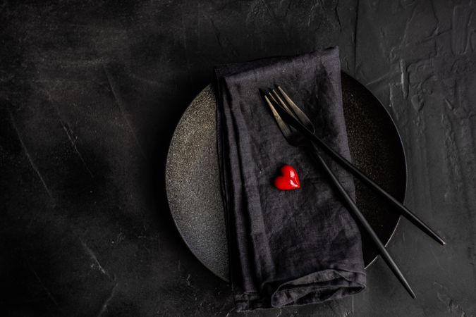 Dark St. Valentine's day table setting with red heart
