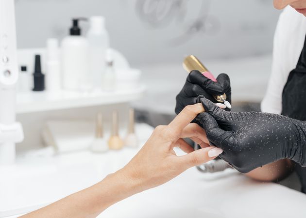 Woman receiving a manicure in salon