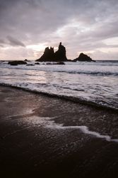 Lonely cliff in sea on cloudy day