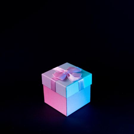 Wrapped present on vibrant bold gradient holographic colors