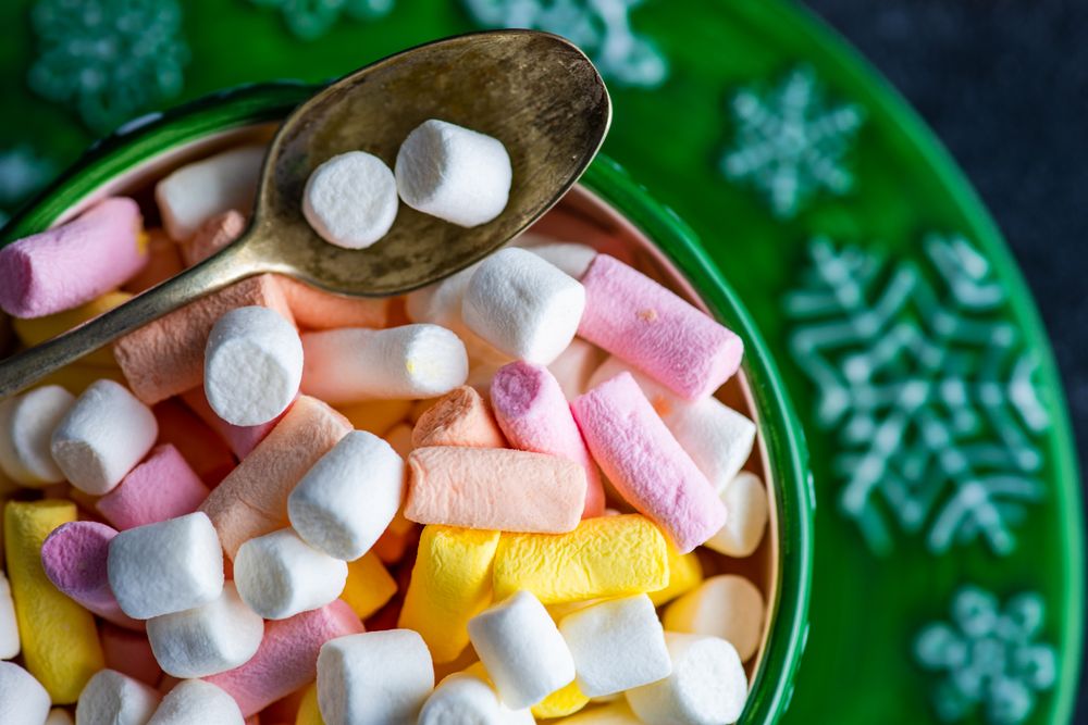Close up of top of marshmallow drink in green cup