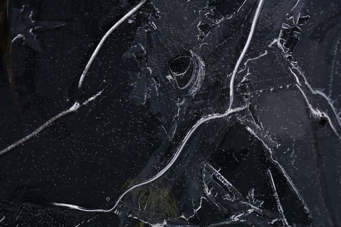 Fragment of thin ice on dark frozen river