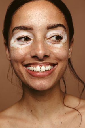 Portrait of smiling woman embracing her skin