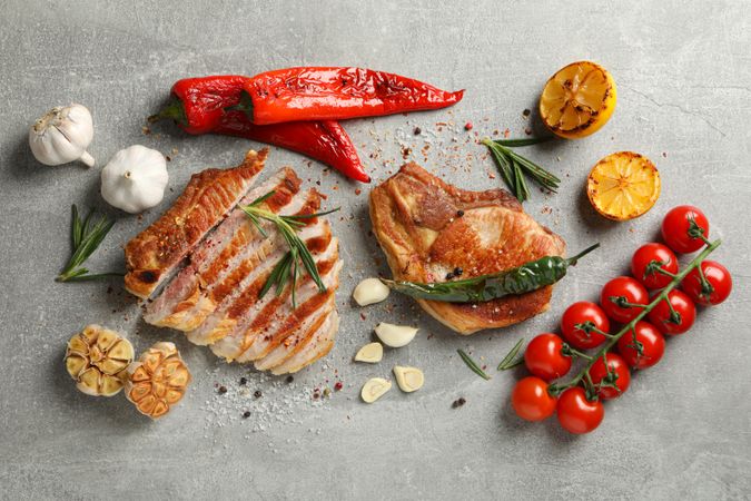 Composition with fried steaks and spices. Grilled food