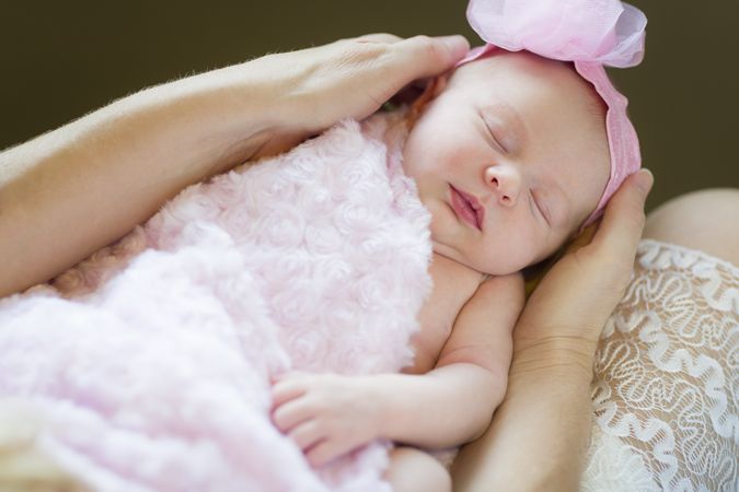 Hands of Mother Holding Her Newborn Baby Girl