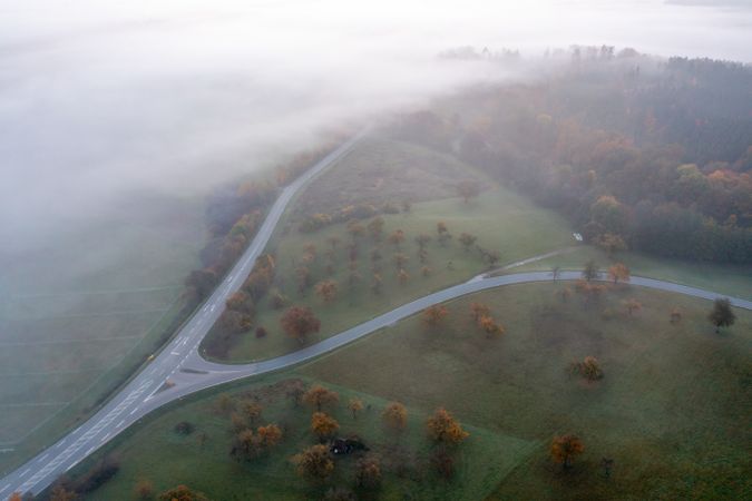 Aerial image with road intersection in an autumn scenery, directly above view on a cold morning in October