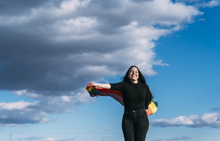 Young woman with rainbow pride flag