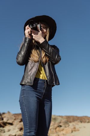 Woman with camera in desert