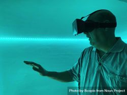 Overwhelmed man wearing virtual reality headset indoor 42x970