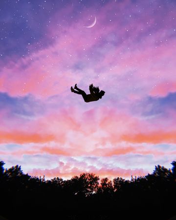 Silhouette of person falling in mid air under blue sky during sunset