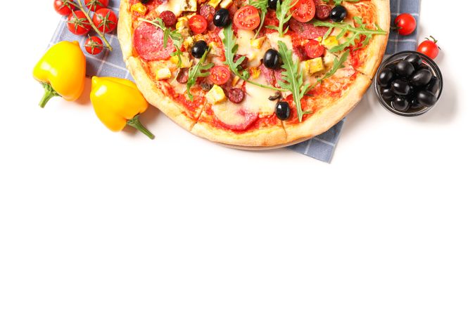 Tasty pizza, ingredients and towel isolated on blank background