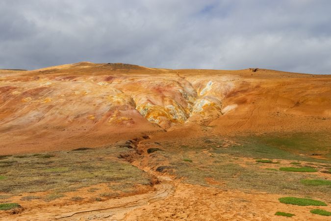Geothermal area showing colorful rhyolite mountains in iceland under cloudy sky