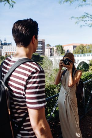 Happy young couple taking selfie in park