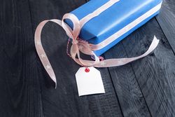 Gift with tag on wooden table