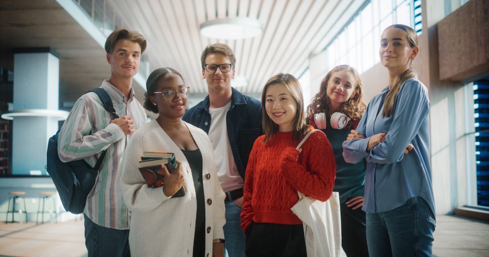 Diverse Group of Students Standing Together in Modern University Hallway.