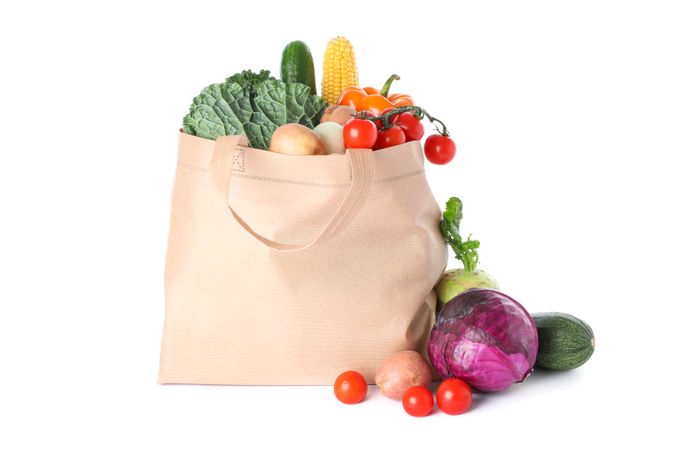 Tote bag with different vegetables isolated on blank background