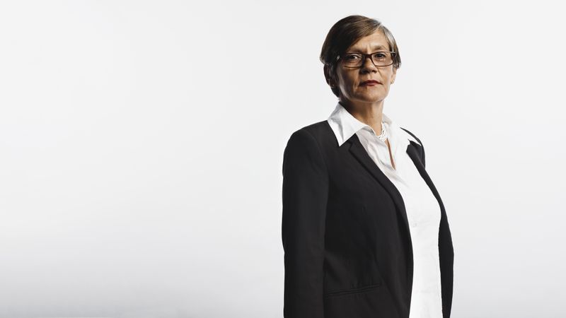Side view of a mature woman in eyeglasses wearing a formal business attire