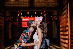 Laughing couple against building entrance