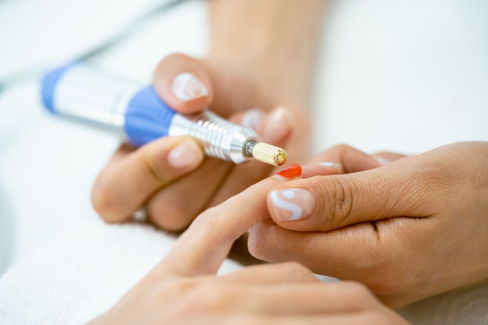 Close up of nails being buffed professionally
